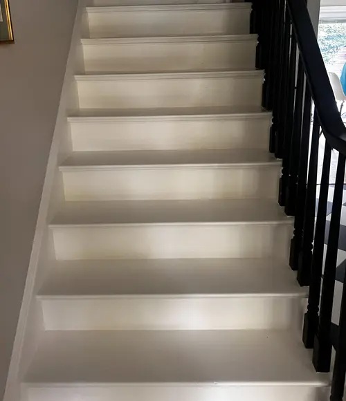 Bare painted staircase in London, Ontario before carpet installation, ready for renovation