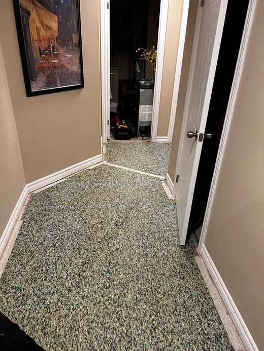 Basement hallway with old underpad in Pond Mills, London, Ontario before carpet installation, ready for new flooring