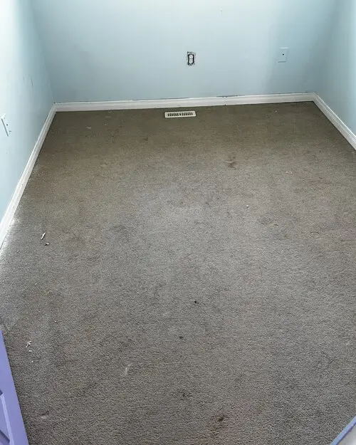 Bedroom with old carpet in Westmount, London, Ontario before carpet replacement, ready for new flooring