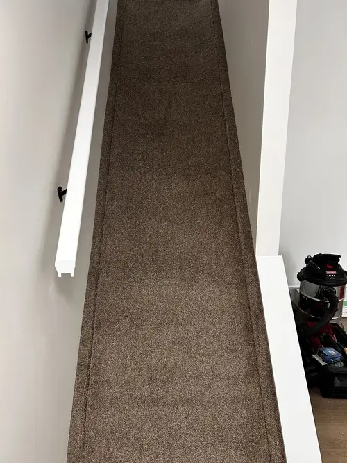 Dark grey carpet loose on staircase in Masonville, London, Ontario before professional installation