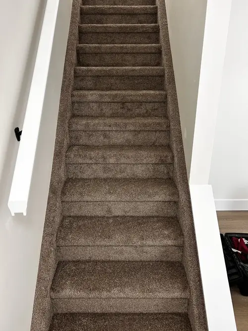 Dark grey carpet professionally installed on staircase in Masonville, London, Ontario after installation