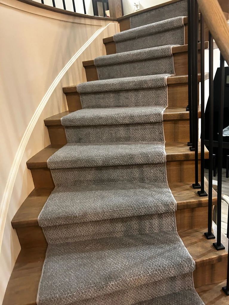 Grey pattern carpet runner installed on hardwood stairs – stylish and durable stair runner in London Ontario home