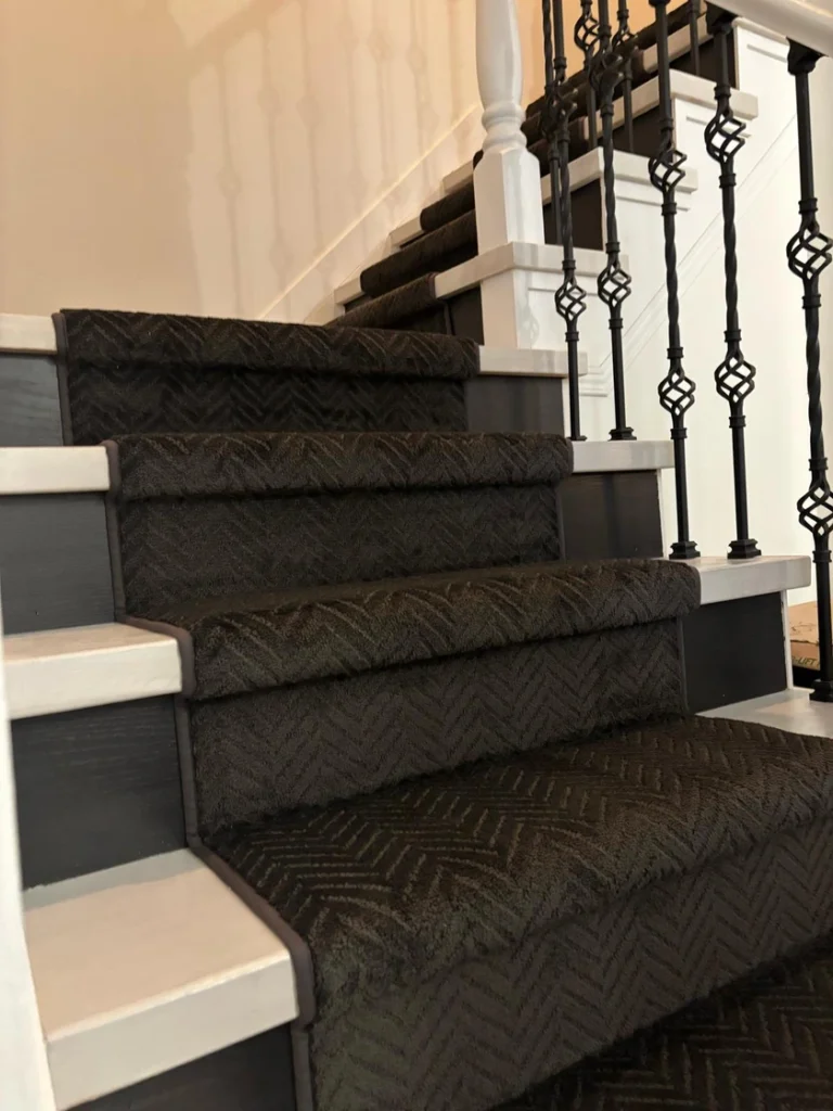 Black herringbone carpet installed on a hardwood staircase in London Ontario.