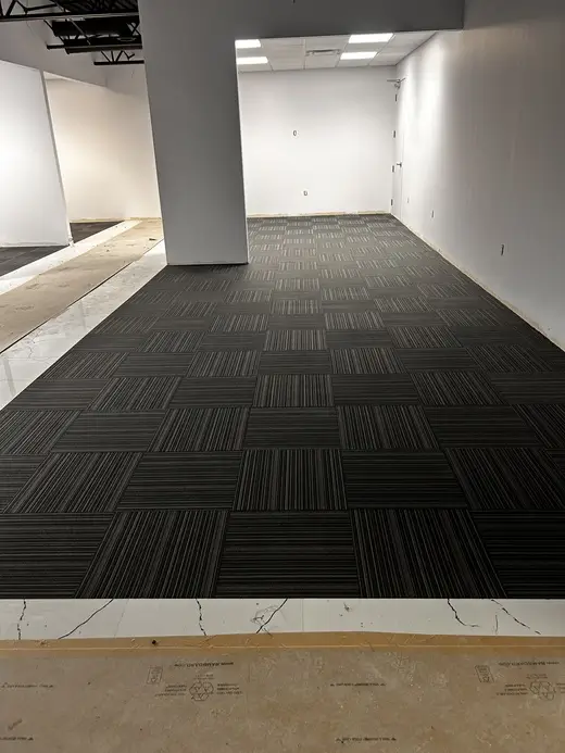 linear design commercial carpet tiles installed in large office lounge in Downtown London after professional installation