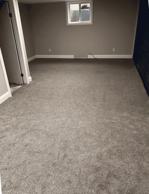 New basement carpet installation in Old East Village, London, Ontario after professional installation, warm and finished look