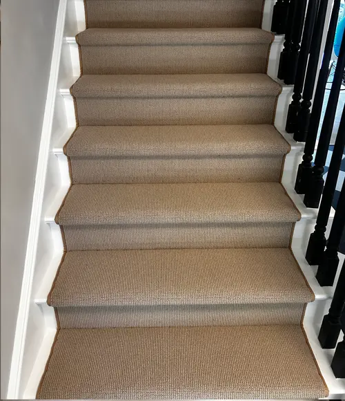 New carpeted staircase in London, Ontario after professional carpet installation, warm and inviting finish.