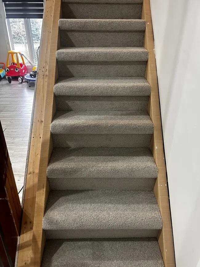 Thick grey carpet professionally installed on staircase in St. Thomas, Ontario after renovation