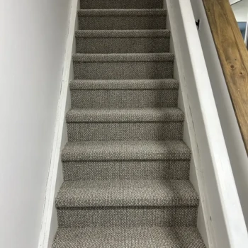 Finished Berber carpet on a home staircase in London, Ontario, installed by Master Carpet