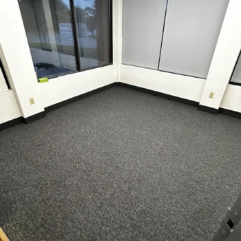 Office room with black commercial carpet installed wall-to-wall in London Ontario, durable and professional flooring