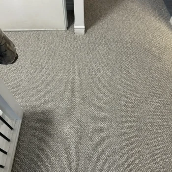 Neutral toned Berber carpet installed in a hallway in London, Ontario showing a clean professional carpet installation