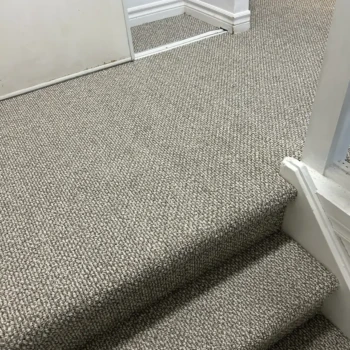 Neutral Berber carpet professionally installed on residential stairs in London, Ontario by Master Carpet