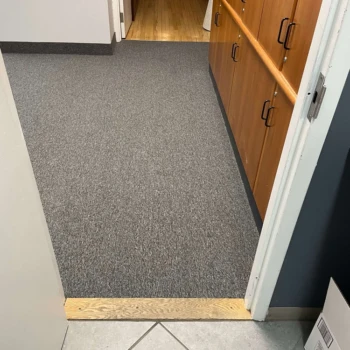 Streaming Aspect commercial carpet in rehab center transition area from tile to wood floor, London Ontario.